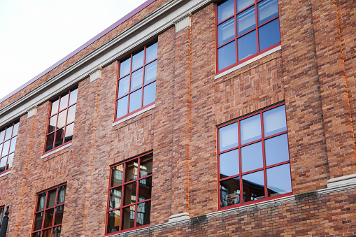 Brick building against blue sky, symbolizing stability and architectural legacy