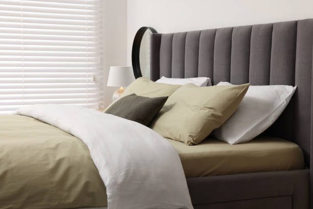 istock Window with horizontal blinds and comfortable bed in room 1885749511