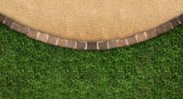 istock Fresh green grass, stone tiles and sand outdoors, top view. Banner design 1885751364