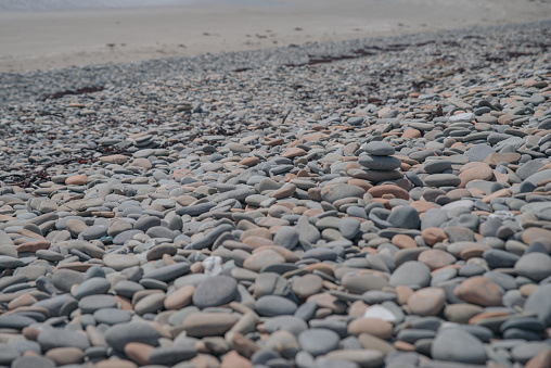 Zen like balanced stones on a pebble beach during sunset, lens flare. Alternative therapy.