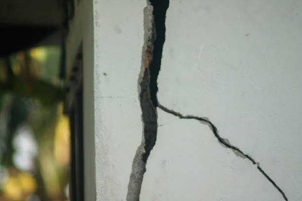 istock Gray cracked concrete texture background. Big crack on the wall 1885850398
