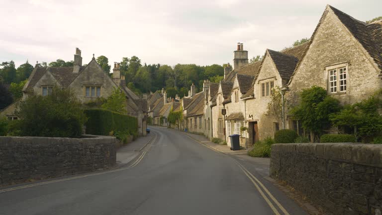 Crossing bridge towards idyllic countryside village with charming stone houses