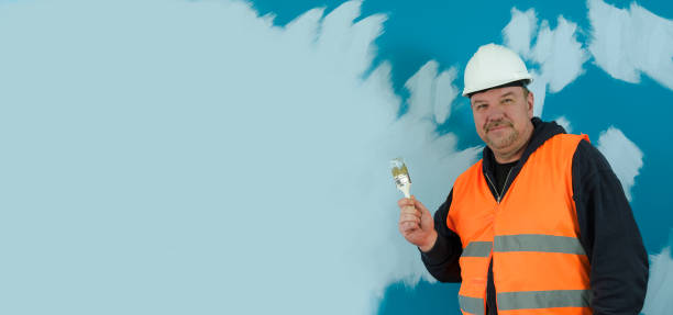 Banner with builder, interior work, painting walls. Place for text. blue wall