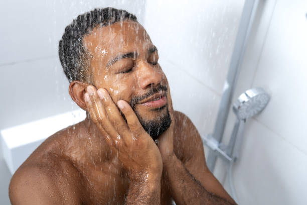 istock Man washing face in shower 1885868864