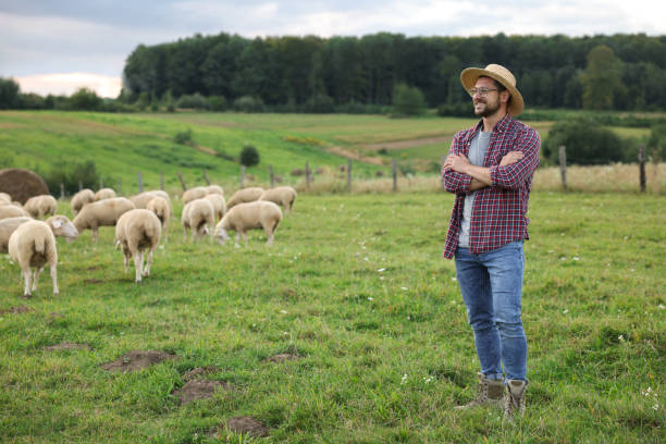 istock Smiling man on pasture at farm. Space for text 1885869407