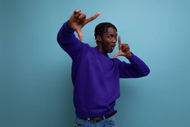 istock positive african american young man with dreadlocks in a blue sweatshirt 1885883706