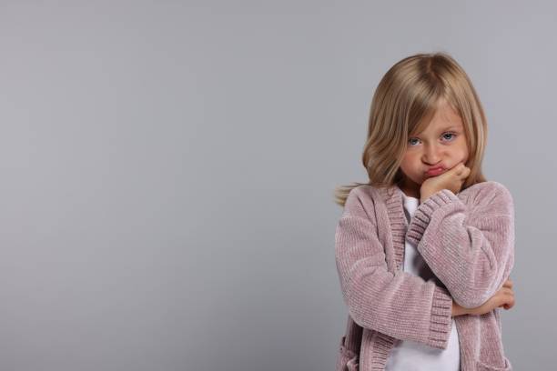 istock Resentful girl on grey background. Space for text 1885896945