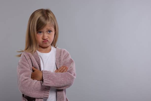 istock Resentful girl with crossed arms on grey background. Space for text 1885896947