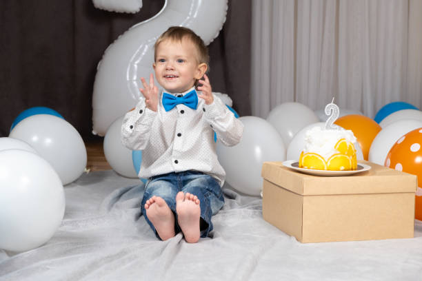 Little funny boy clapping his hands on his birthday