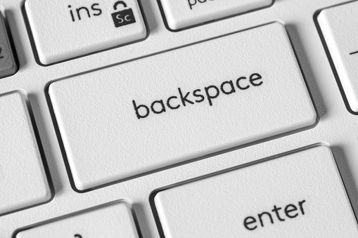Backspace key on white keyboard for technology blogs, graphic design, and educational materials. The perfect visual element symbolizing editing, users control, and seamless navigation.