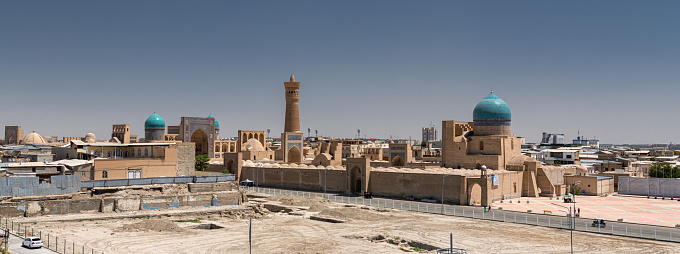 JUNE 27, 2023, BUKHARA, UZBEKISTAN: View over the Poi Kalon Mosque and Minaret from the Ark fortress, in Bukhara, Uzbekistan. Blue sky with copy space for text