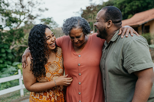 Family hugged laughing outdoors