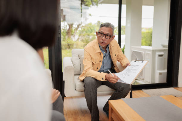 istock Real estate agent talks terms with homebuyers 1886097264