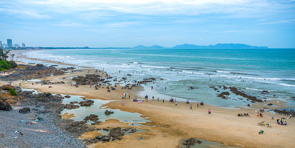 Vung Tau, Vietnam - November 29th, 2023: Pilgrims walk across island to temple to worship goddess for peace their families on full moon day of first lunar month in Vung Tau, Vietnam.