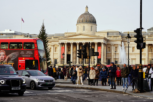 Trafalgar Square, City of Westminster, Central London, England, United Kingdom, Great Britain - December 26th, 2023: Christmas Tree, Christmas Market, and festive activities, decorations, winter markets and several tourists enjoying Festivity in central London, the city of Westminster in England, United Kingdom, Great Britain. Captured in day time.