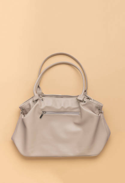 istock A large beige bag with handles on a beige background. 1886149310