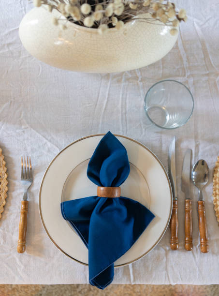 istock Festive white and royal blue table setting with wooden accents 1886180050