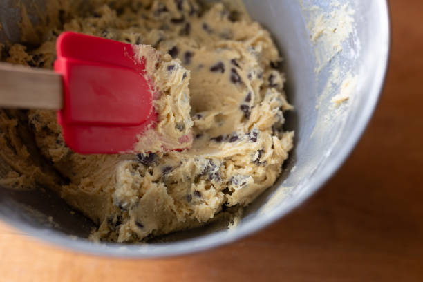 istock chocolate chip cookie dough being stirred with a red spatula 1886187767