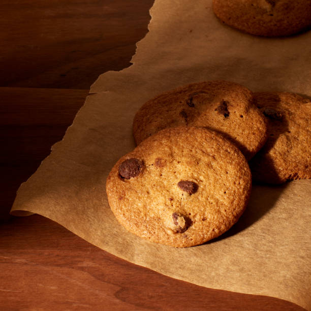 istock Tates cookies on wood with parchment paper 1886201282