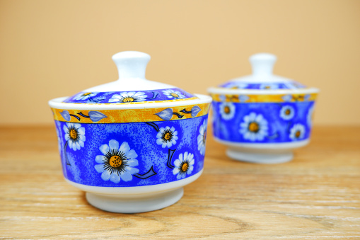 Floral pattern blue color ceramic jars together isolated on color background close-up view
