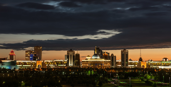 The central part of the capital of Kazakhstan, the city of Astana, and the residence of the President under the disturbing sky at evening twilight
