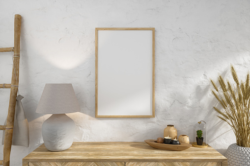 Empty Picture Frame On Wall And Wooden Cabinet With Decorative Objects And Lamp Shade