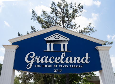 Blue and white entrance sign for Graceland on Elvis Presley Boulevard in Memphis, Tennessee.