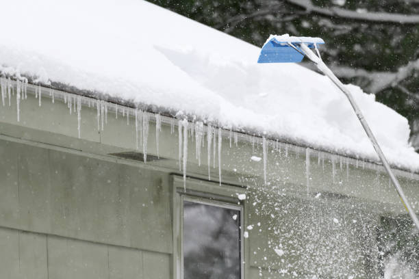 istock removing snow on the roof after snow storm 1886318864