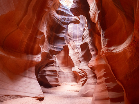 Brilliant orange and peach-colored Navajo sandstone that's eroded to become the Upper Antelope Canyon near Page, Arizona.