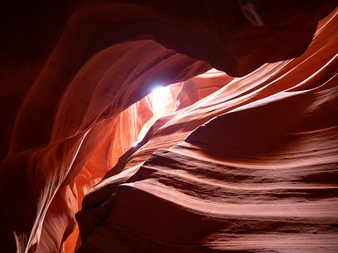 Orange and rust colored striated Navajo Sandstone walls in Upper Antelope Canyon near Page, Arizona.