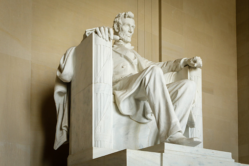 Statue of Abraham Lincoln sculpted by Daniel Chester French (1850–1931) and carved by the Piccirilli Brothers. Located in the Lincoln Memorial (constructed 1914–1922), on the National Mall, Washington, D.C., United States, the statue was unveiled in 1922. The work follows in the Beaux Arts and American Renaissance style traditions.