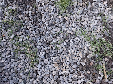 landscape orientated background with pattern of gravel stone and grass