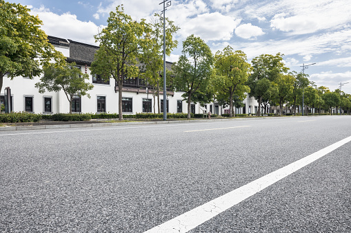 Low angle view of asphalt road and buildings