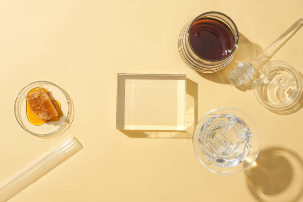 istock On a pastel background, an empty glass podium sets the stage for product display, featuring stored honey in glassware. Honey accelerates skin cell recovery, addressing a key factor in eczema. 1886435399