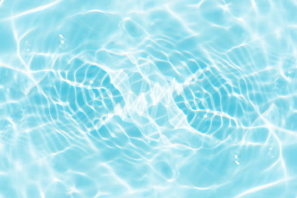 istock Bluewater waves on the surface ripples blurred. Defocus blurred transparent blue colored clear calm water surface texture with splash and bubbles. Water waves with shining pattern texture background. 1886485480