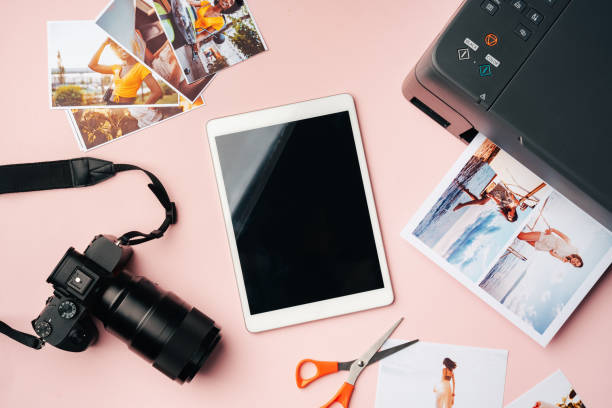 istock Printer, photo camera and digital tablet on table. Printing photos concept 1886491172
