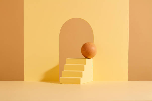 istock A wooden ball is placed on a ladder-shaped platform. Minimal creative composition background for cosmetics or products presentation. Front view. Advertising. 1886492200