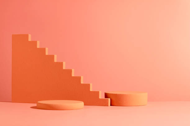 istock The orange display platforms stand out against the vibrant red background. Cosmetics advertising space with empty space. Spa, cosmetics, beauty display concept. 1886493218