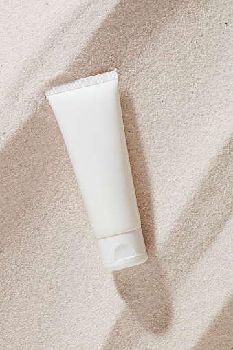 Nature-inspired tube holds essential moisturizing cream. Perfect for face, body, and sun protection. Elevate your skincare routine with this beauty must-have. Skincare essentials concept.