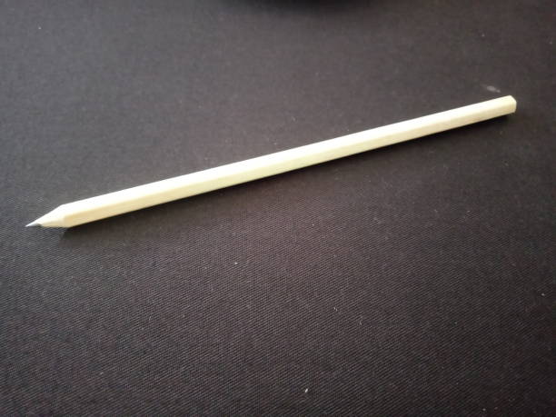 wooden pencil on a black cloth background