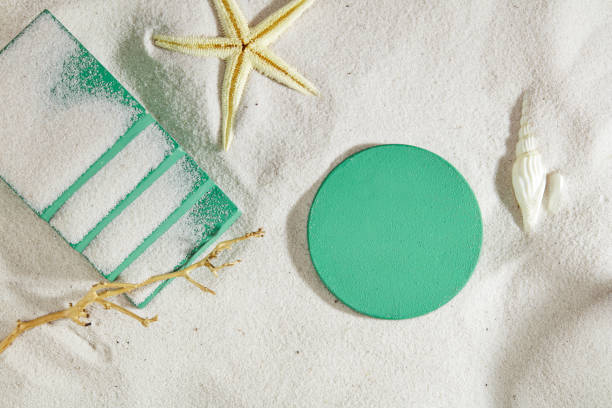 istock Sea shells and turquoise platforms stand out against the white sand background. Ideal space for displaying products, especially cosmetics. Concept of natural beauty. 1886529572