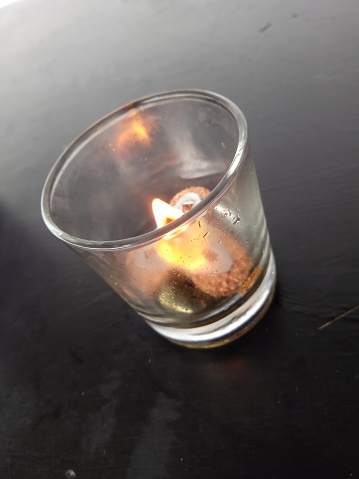 candles in small glasses on the dining table