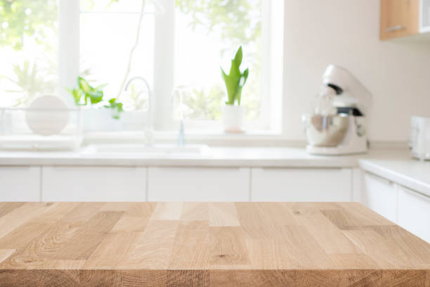 istock Empty beautiful wooden table top and blurred modern kitchen interior background 1886572873