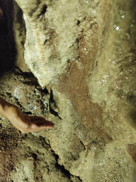 istock Transient Harmony: Hand and Water Droplet on Limestone Surface 1886595955