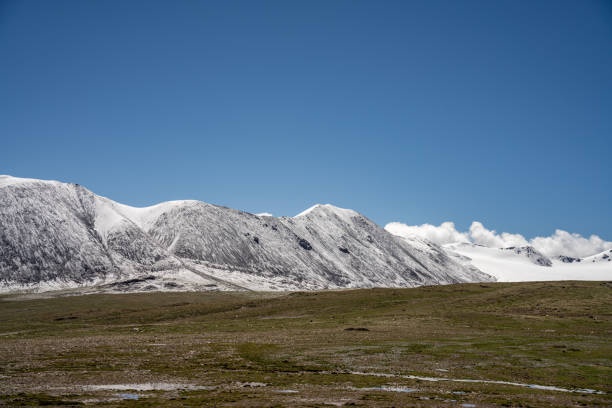 istock Snowy mountains and grasslands on the plateau 1886647827