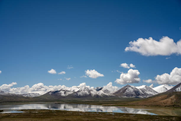 istock Mountains, meadow, and river on a sunny plateau 1886648872