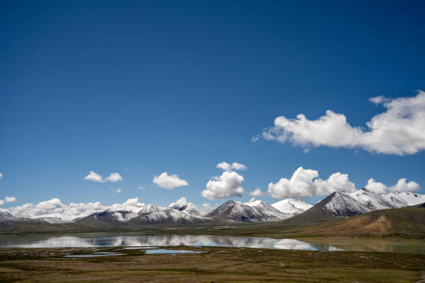 istock Mountains, meadow, and river on a sunny plateau 1886649393