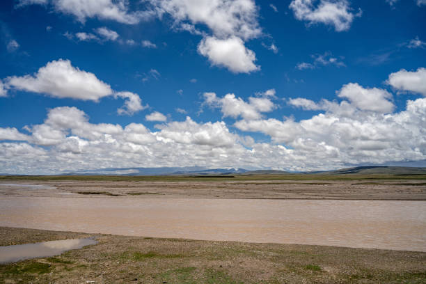 Mountains, meadow, and river on a sunny plateau