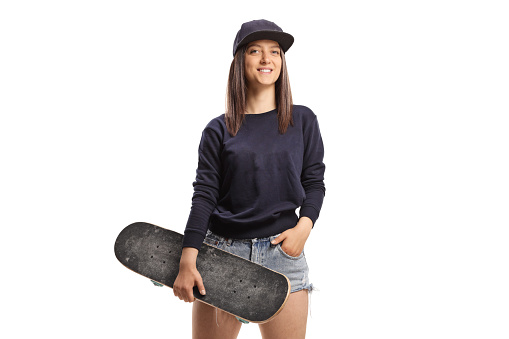 Skater girl holding a skateboard isolated on white background