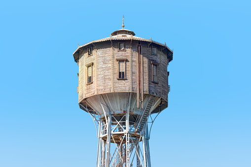 Abandoned water tower tank from below with a bright blue sky near Nile river - Egypt